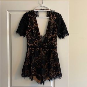 Black lace low cut/open back romper